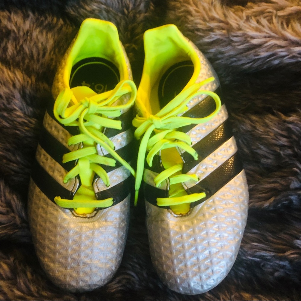 Child’s silver and neon green Adidas cleats size 1